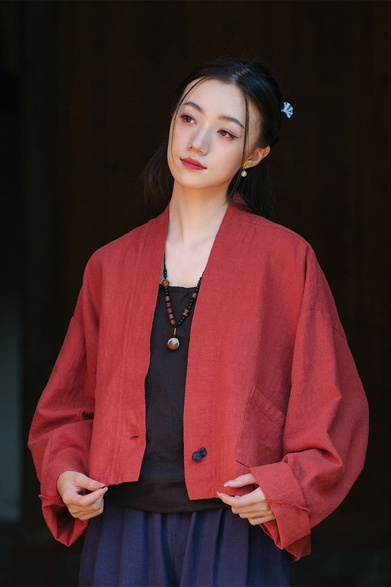 Woman wearing a one size fits all red ramie linen and cotton open-front cardigan with relaxed fit and side pocket.