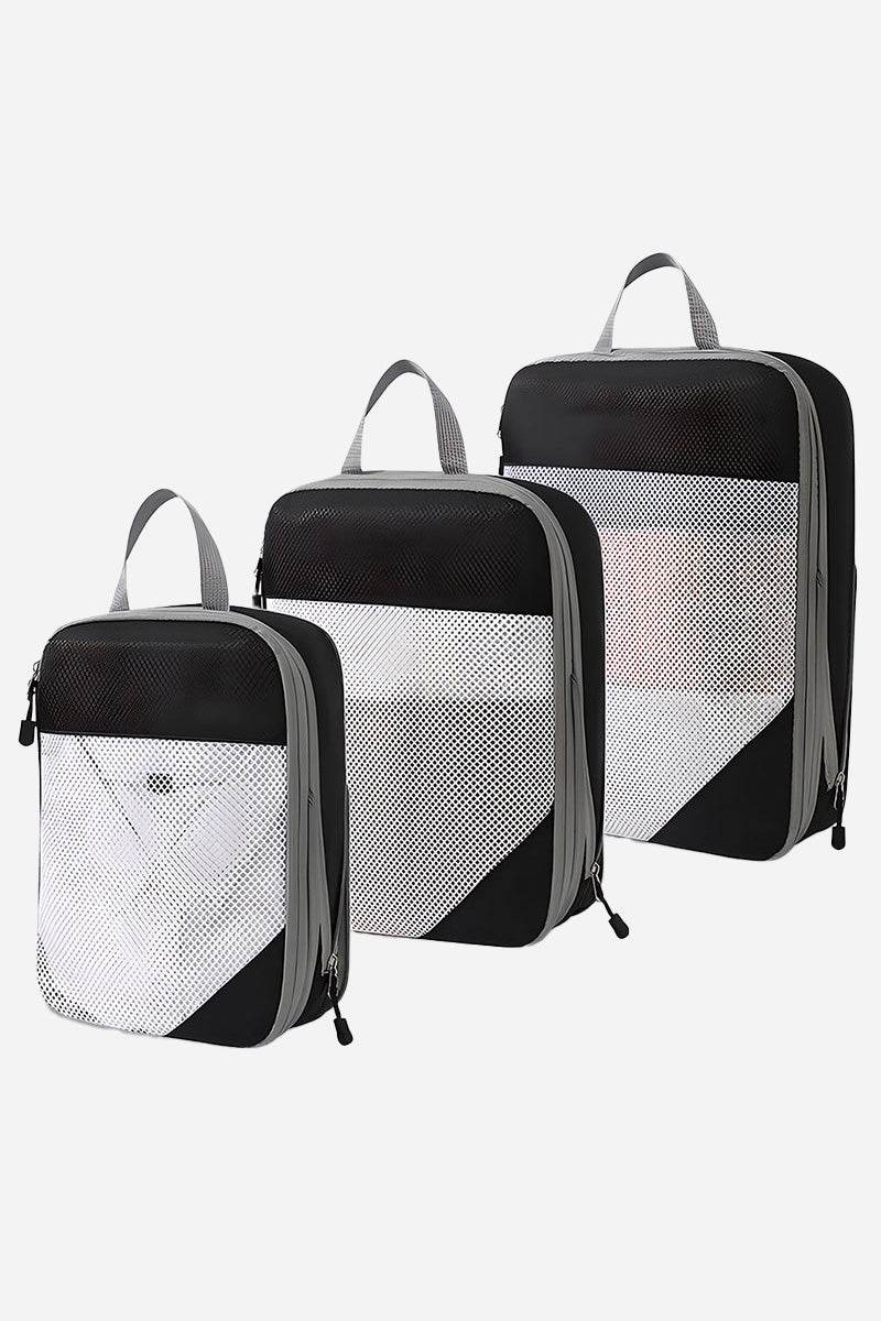 Set of three space-saving compression packing organizers with black and white design, mesh front panels, and zipper closures for efficient travel packing.