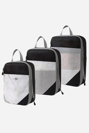 Set of three space-saving compression packing organizers with black and white design, mesh front panels, and zipper closures for efficient travel packing.