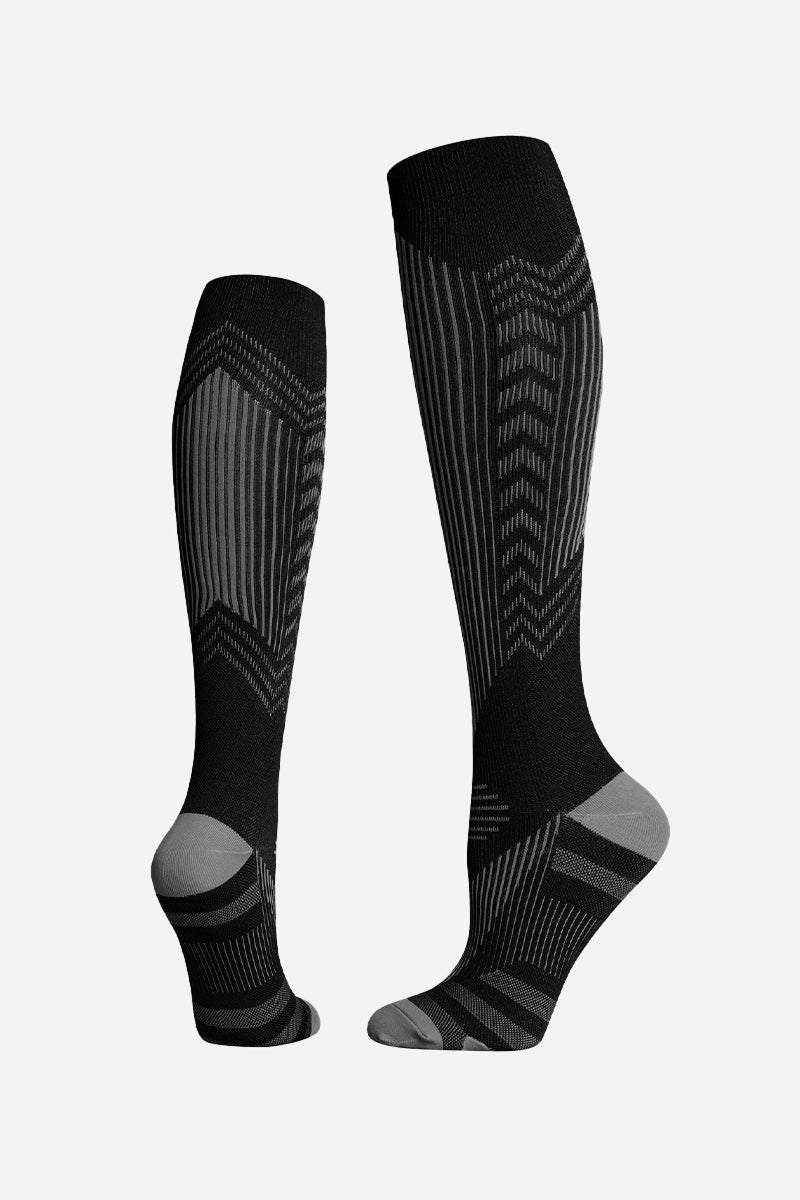 Black and gray premium compression travel socks with gradual compression technology for leg support and comfort