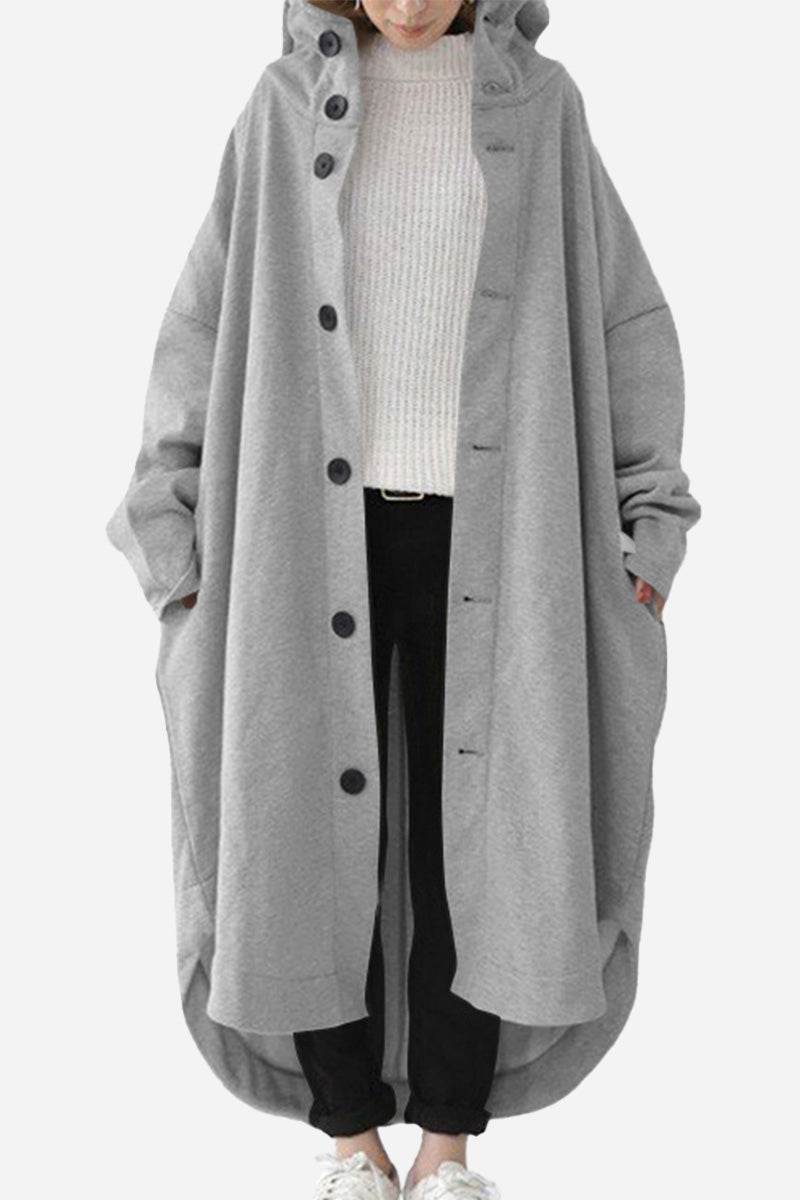 Oversized gray buttoned hooded coat in lightweight breathable fabric with roomy pockets, styled for everyday travel comfort.
