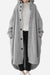 Oversized gray buttoned hooded coat in lightweight breathable fabric with roomy pockets, styled for everyday travel comfort.