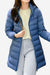 Women wearing lightweight blue water-resistant hooded puffer coat with long sleeves and zip front over casual outfit