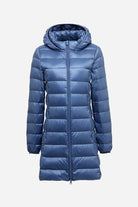 Women's lightweight water-resistant hooded puffer coat in blue with front zipper and quilted design