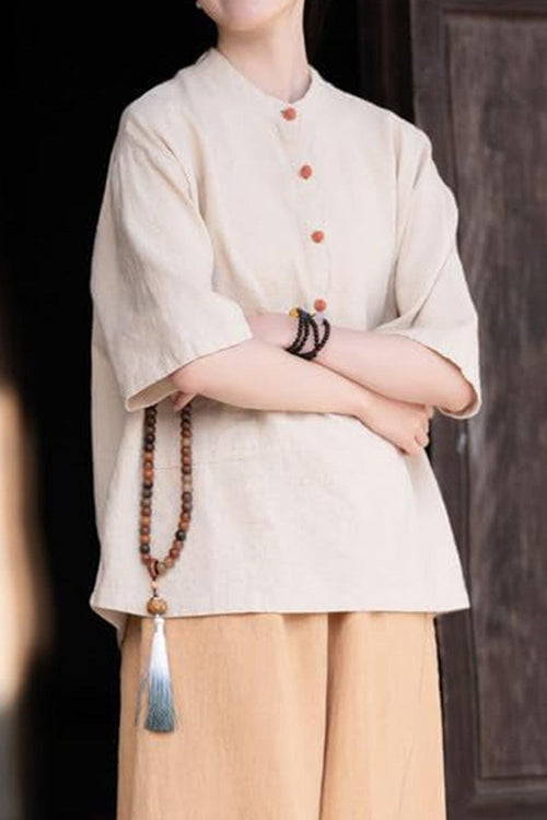 One size fits all ramie linen and cotton shirt with short sleeves and wooden buttons, styled with neutral pants and accessories