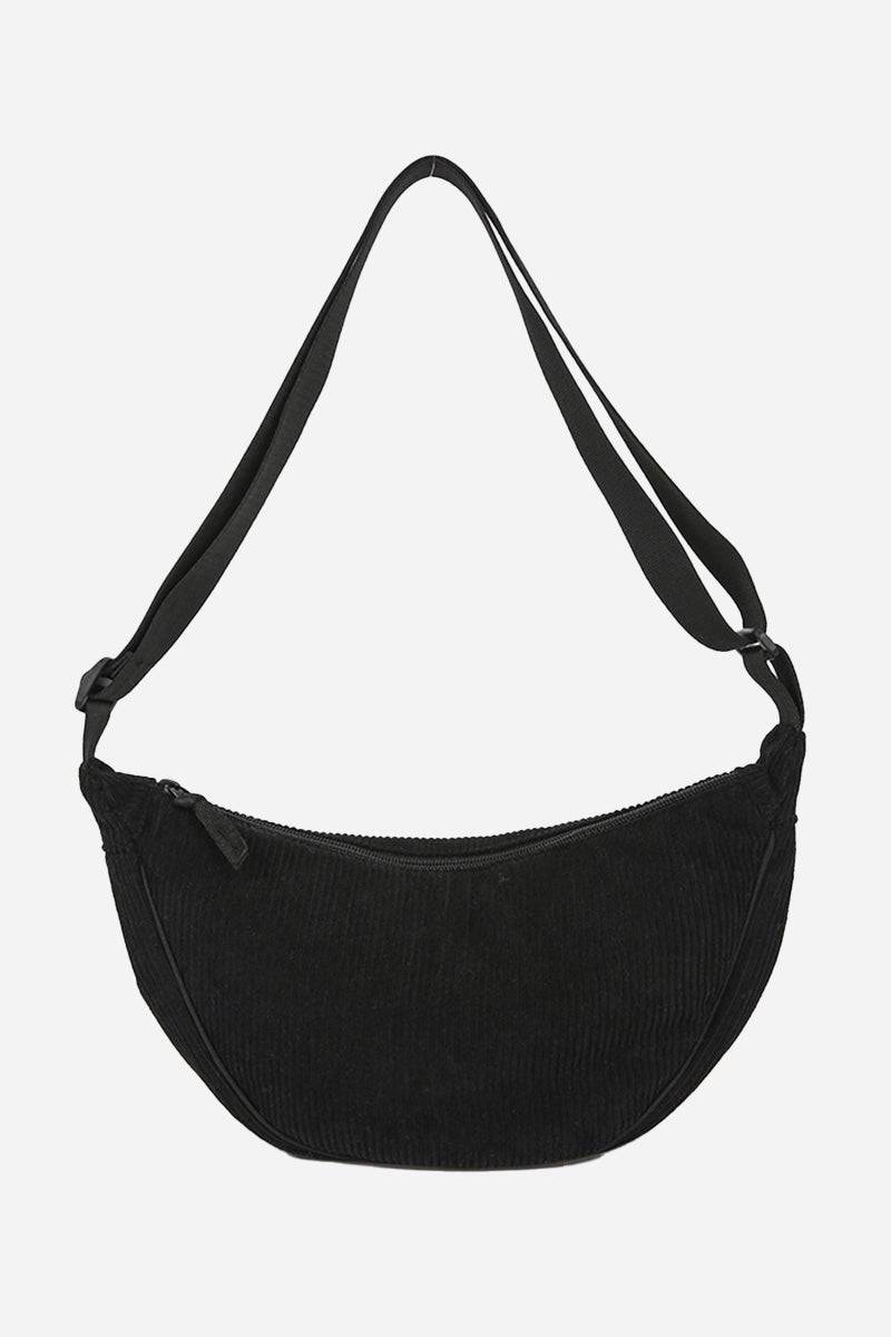 Black corduroy shoulder bag with adjustable strap and zip closure, lightweight and roomy design.