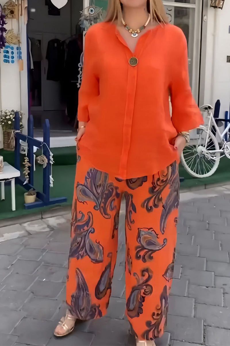 woman wearing vibrant fusion two-piece set with orange top and patterned wide-leg pants