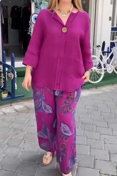 Woman wearing vibrant fusion two-piece set with solid fuchsia top and printed floral pants outdoors