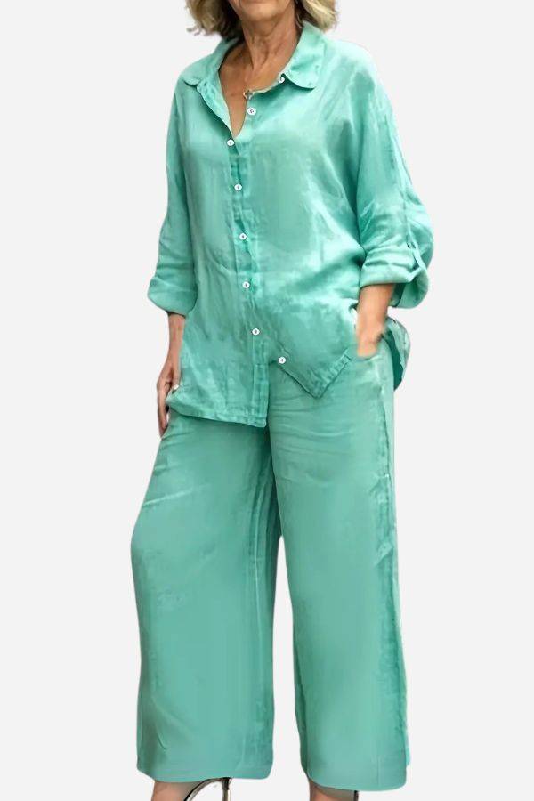 Woman wearing a loose-fitting mint green cotton blend two-piece set with button-up top and wide-leg pants.