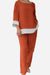 Woman wearing a dual-tone 3/4 sleeve orange and white two-piece set with relaxed fit pants and top.
