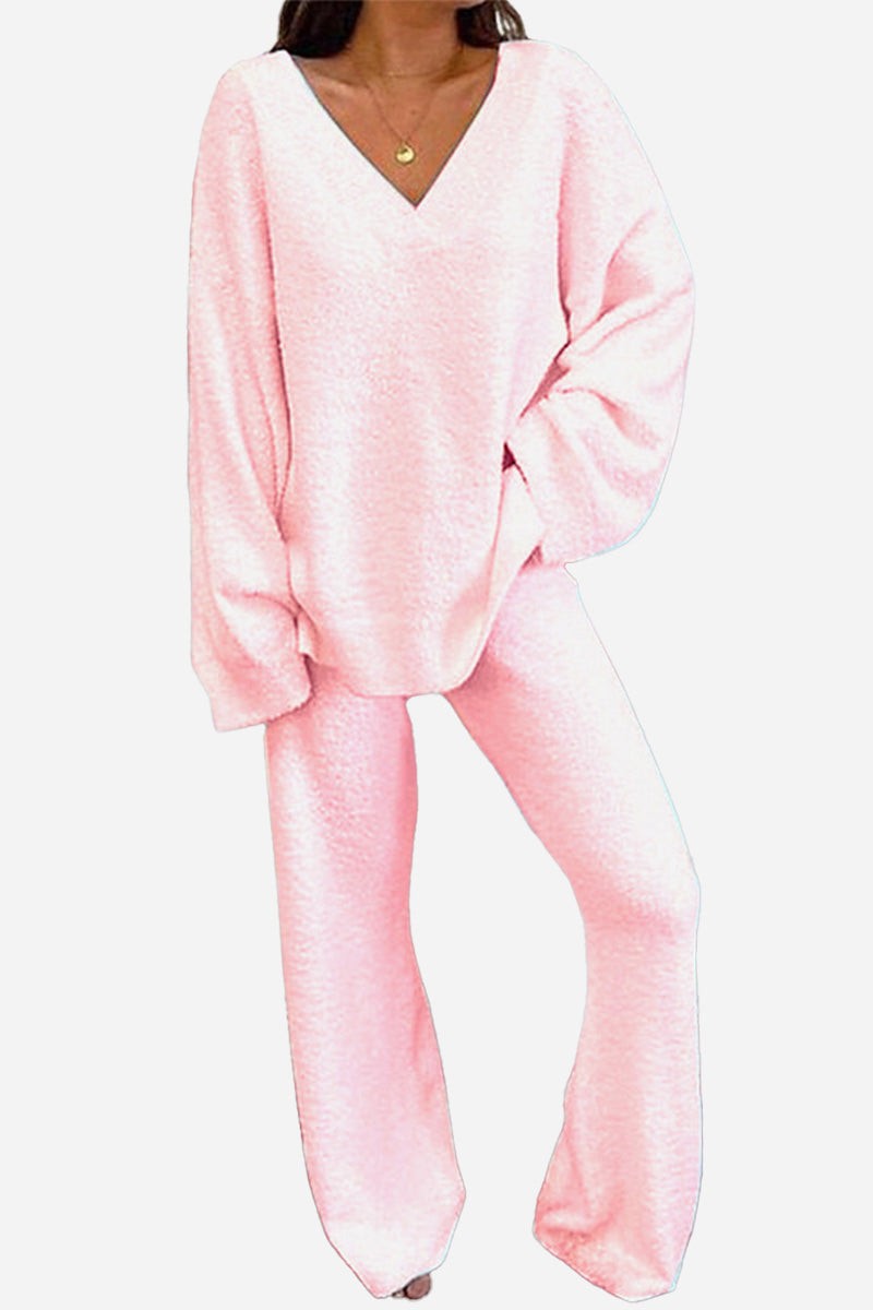 Woman wearing soft pink Travel-Ease Two-Piece Set with relaxed fit top and comfortable pants designed for travel and lounging