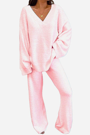 Woman wearing soft pink Travel-Ease Two-Piece Set with relaxed fit top and comfortable pants designed for travel and lounging