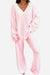 Woman wearing soft pink Travel-Ease Two-Piece Set with relaxed fit top and comfortable pants designed for travel and lounging
