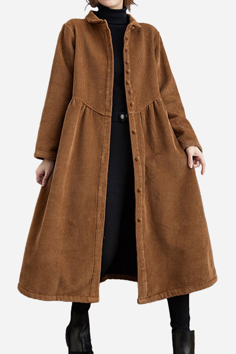 Woman wearing oversized vintage brown corduroy coat with button closure and gathered waist over black outfit