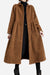 Woman wearing oversized vintage brown corduroy coat with button closure and gathered waist over black outfit