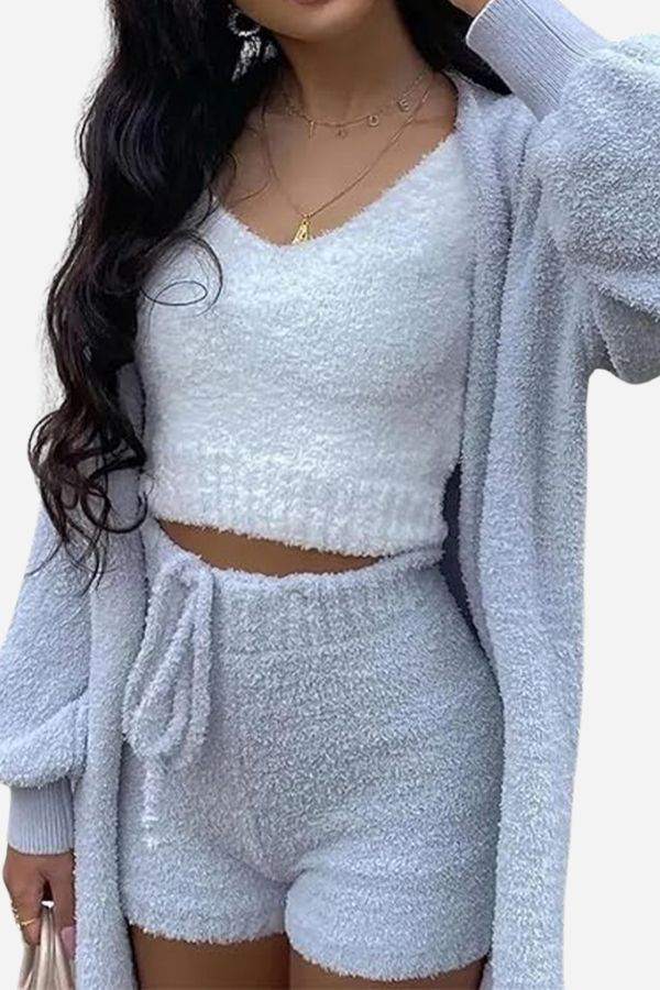 Woman wearing Cloud Soft 4-Piece cozy light gray plush loungewear set with cardigan, crop top, and shorts