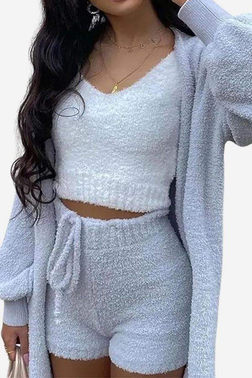 Woman wearing Cloud Soft 4-Piece cozy light gray plush loungewear set with cardigan, crop top, and shorts