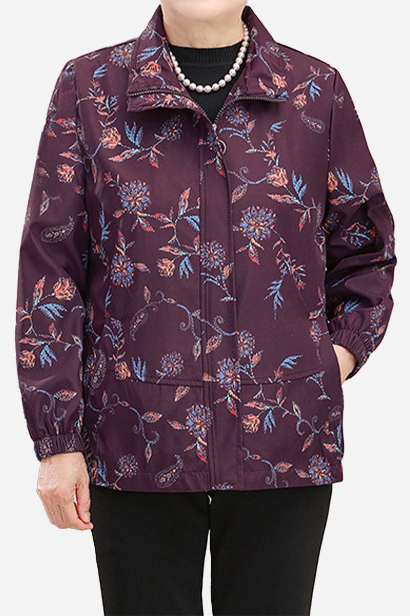 Plus size floral WeatherShield jacket in purple with water-resistant fabric and wind protection, designed for comfort and travel.