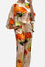 Plus size vibrant floral matching set with flowy silhouette in orange and green floral patterns