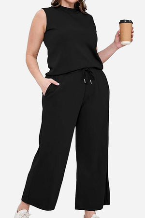 Cotton Chic Sleeveless black two-piece set with relaxed fit and pockets, perfect for travel and casual elegance