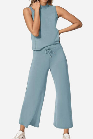 Woman wearing light blue cotton chic sleeveless two-piece set with wide-leg pants and sleeveless top