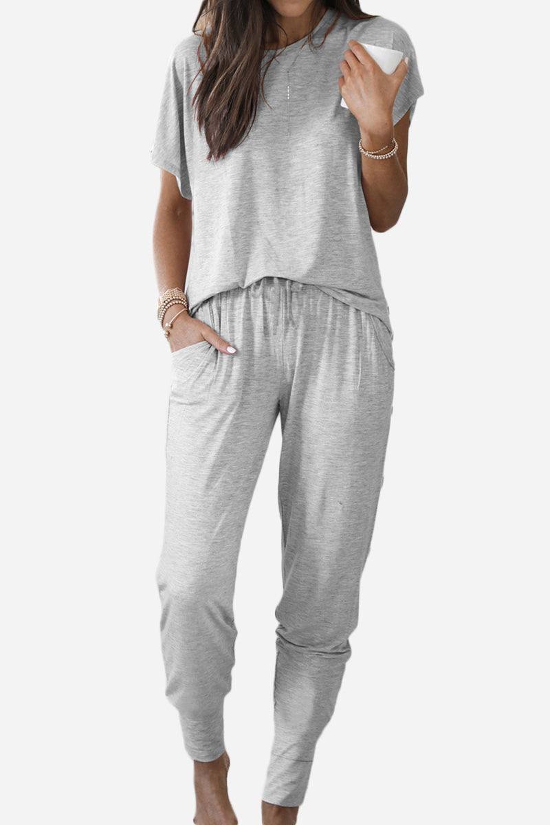 Woman wearing a light gray ultra-soft two-piece loungewear set with short sleeves and jogger pants with pockets.