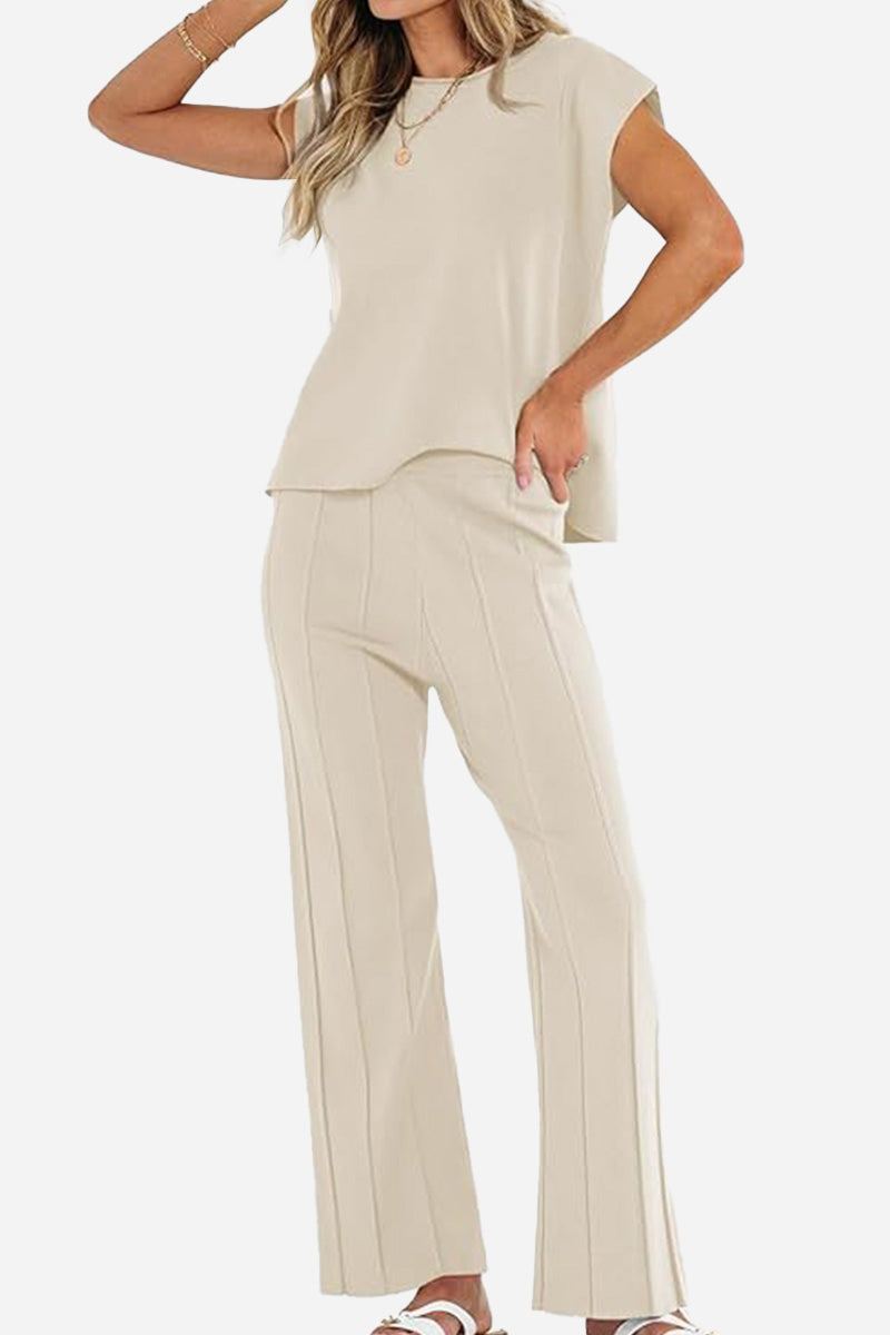 Beige first class travel two-piece set with pleated wide-leg pants and a loose short-sleeve top for wrinkle-resistant comfort and style