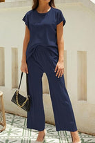 First Class Travel two-piece navy set with pleated wide-leg pants and short-sleeve top for wrinkle-resistant comfort and versatile elegance
