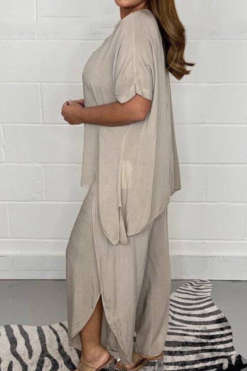 Relaxed linen-like travel two-piece set in beige with loose fit and side slits worn by woman