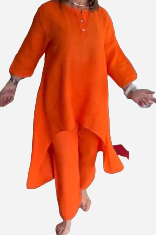 woman wearing breathable and featherlight vibrant orange two-piece lounge set with long top and pants