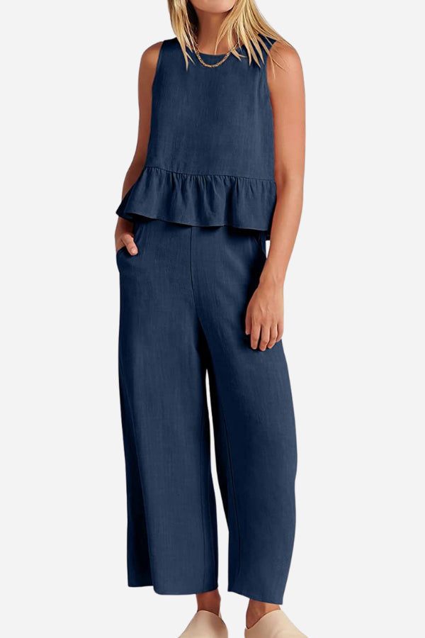 Woman wearing navy blue sleeveless linen-like feel set with peplum top and wide-leg pants