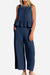 Woman wearing navy blue sleeveless linen-like feel set with peplum top and wide-leg pants