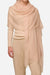 Lightweight 100% cashmere featherlight luxury scarf in soft beige draped over a model's shoulders