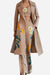 Three-piece floral set with beige coat, strapless top, and wide-leg pants featuring colorful floral prints