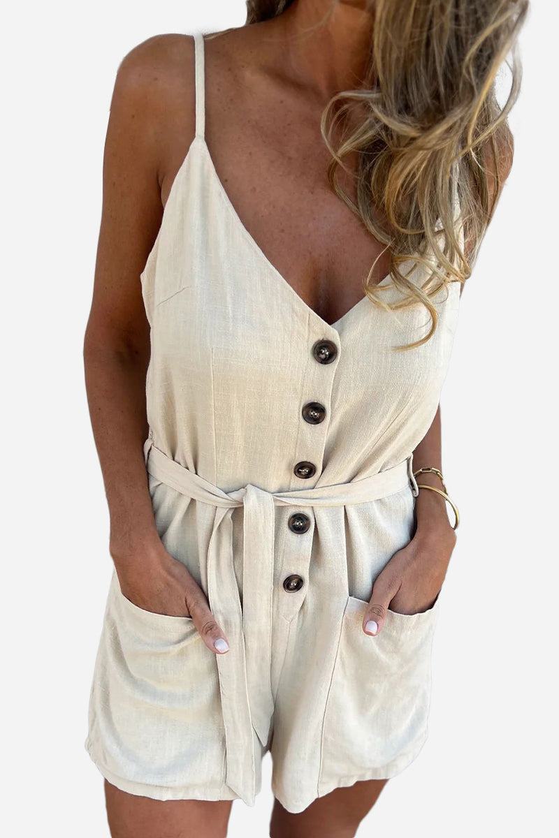 Woman wearing 100% pure linen breathable natural comfort jumpsuit with button front, adjustable waist tie, and pockets in beige color