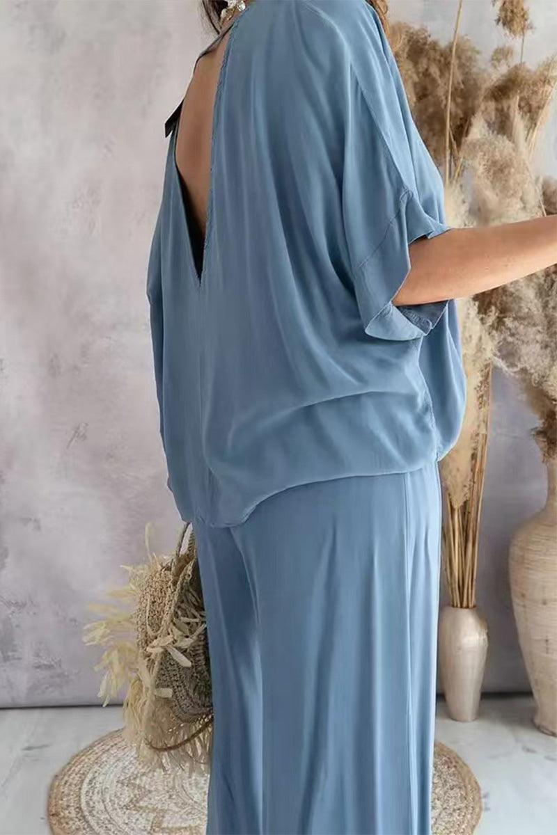 light blue two-piece pantsuit with V-neck and flowy short sleeves on model