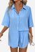 Woman wearing a light blue coastal linen cotton two-piece set with button-up shirt and shorts.