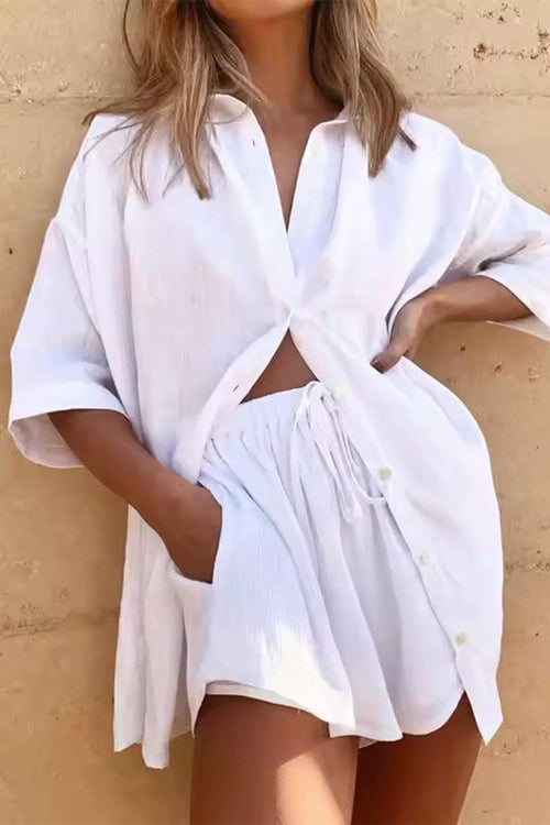 woman wearing white coastal linen cotton two-piece set with button-up shirt and shorts