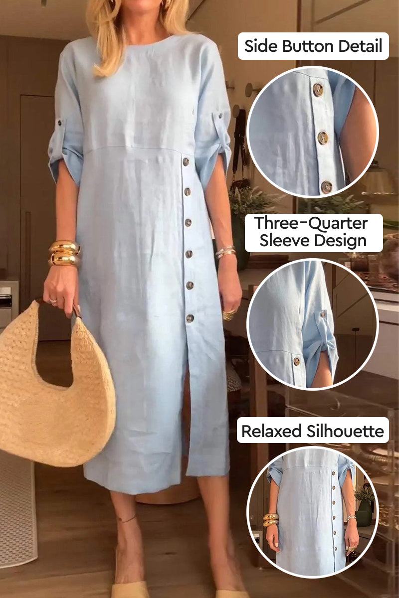 Light blue Pure Cotton Elegance dress with side button detail, three-quarter sleeves, and relaxed silhouette worn with a woven handbag and bracelets