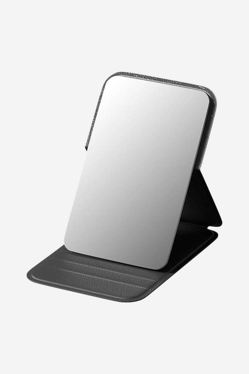 Compact travel pocket mirror with durable black PU leather case and clear glass reflection surface