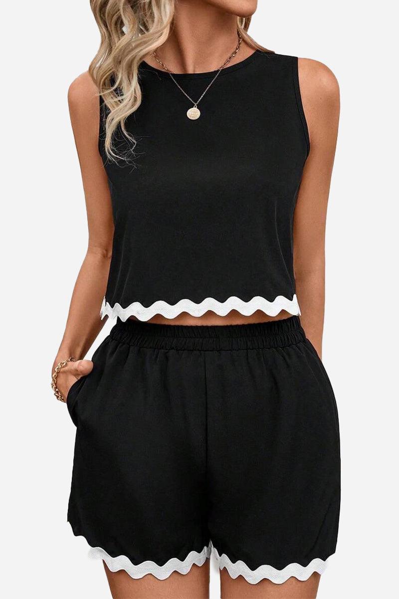 Black sleeveless two-piece set with white scalloped hem on top and shorts, flattering coastal scallop style.