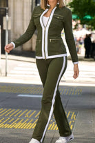 Woman wearing green contrast zip two-piece outfit with white stripe and zipper details walking outdoors