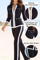 Black contrast zip two-piece with tailored zip-front jacket, gold zipper details, and sporty white side stripes.