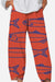 Breathable cropped pants with artistic sardine pattern in red and blue, featuring a relaxed fit and comfortable waistband.
