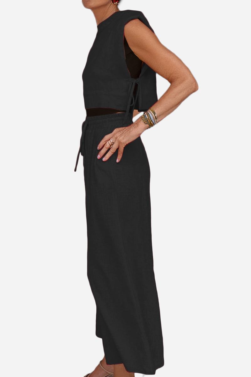 woman wearing breathable cotton-linen blend black sleeveless two-piece outfit with wide-leg pants