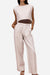 Woman wearing beige cotton-linen blend wide-leg pants and cropped sleeveless top summer outfit