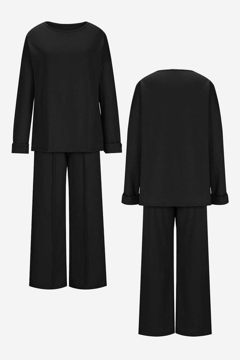 Black comfortable travel-ready two-piece set with relaxed fit long-sleeve top and wide-leg pants, wrinkle-resistant fabric.