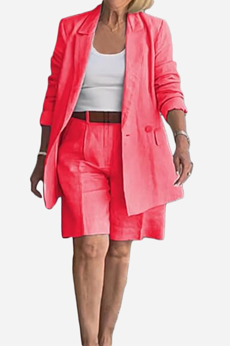 Woman wearing vibrant pink stylish blazer and shorts set with white top and brown belt