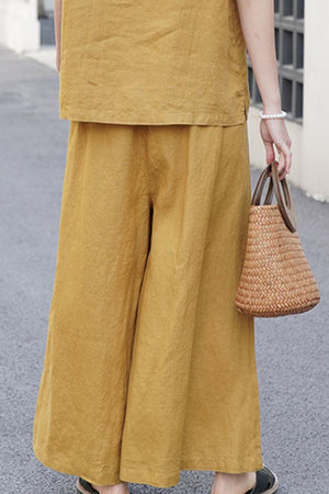 Mustard yellow wide-leg pants made from 100% linen for breathable, comfortable wear.
