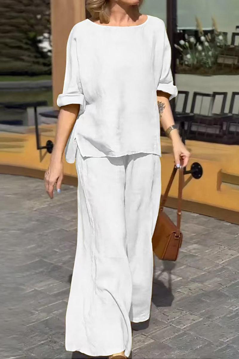 Woman wearing a white 100% cotton two-piece set with a round neck top and wide-leg pants outdoors